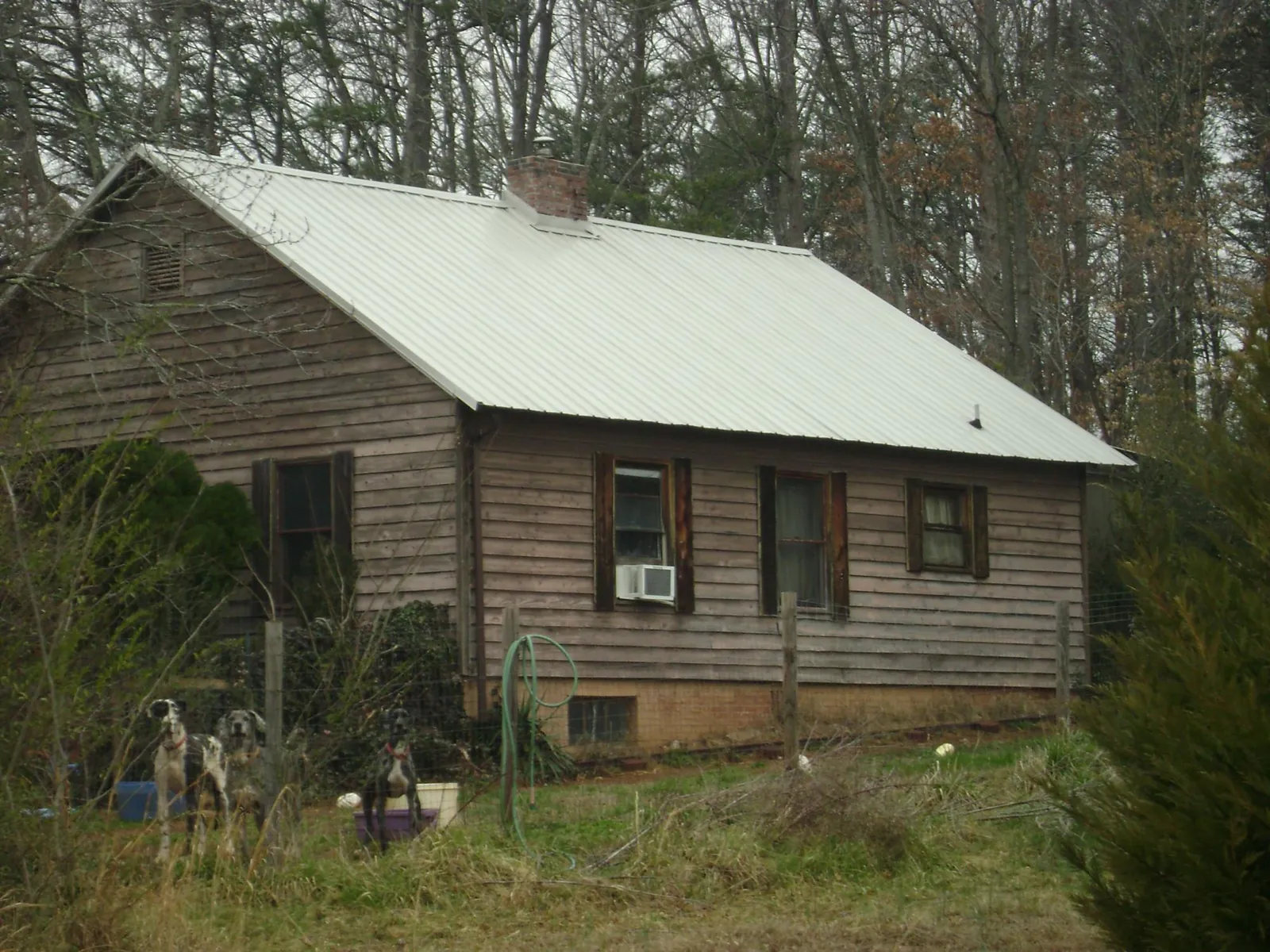 White metal roof on an old wood sided farmhouse, from a Metal Roof Installation job in Solen
